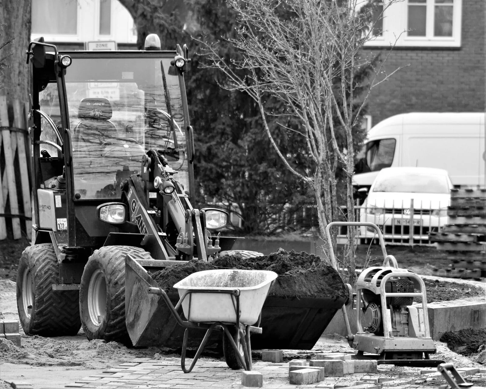 Loader moving soil on a residential street